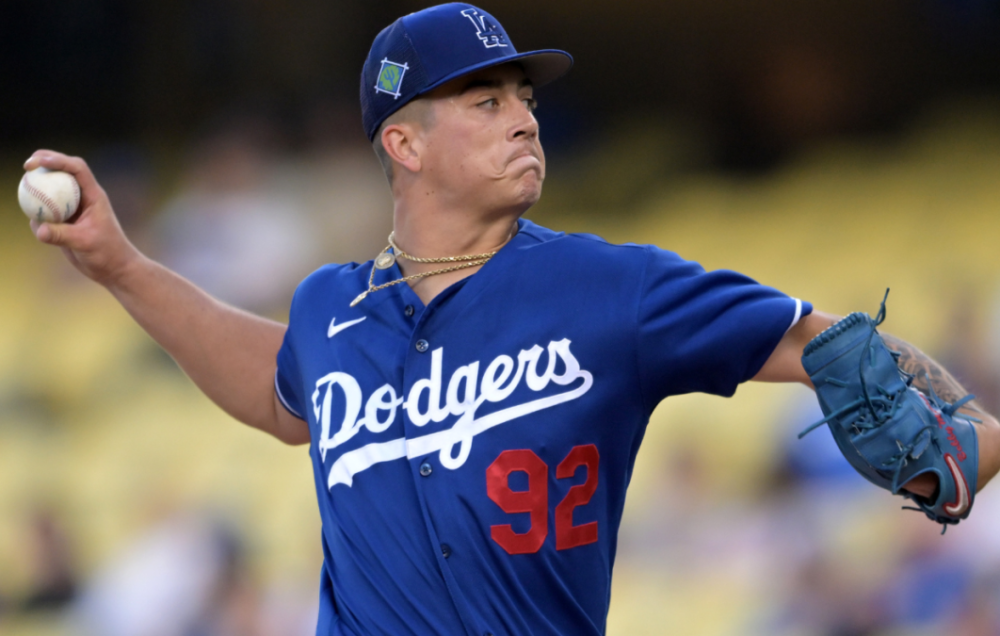 Dodgers RHP Bobby Miller - pictured throwing a baseball while wearing a dark blue team jersey